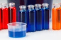 Blue, red and orange liquid in chemical lab test tubes on white background Royalty Free Stock Photo