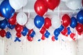 blue and red party balloons against a white ceiling Royalty Free Stock Photo