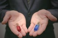 Blue and red pill choosing concept. Steroid or drug selecting.