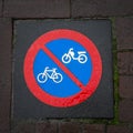 Blue and red road sign on the sidewalk bike path. Square format. Close-up Royalty Free Stock Photo