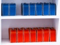 Blue and red toy cases on the shelf background Royalty Free Stock Photo