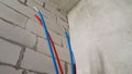 Blue and red water hoses. Hydraulic equipment with hoses. Plumbing in the bathroom.