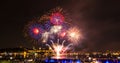 Blue, red, and white fireworks over the Saint-Lawrence River Royalty Free Stock Photo