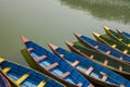 A Blue red yellow green old wooden boats on the water. rowing boats on the lake