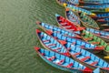 A Blue red yellow green old wooden boats on the water. rowing boats on the lake. small waves on the surface of the water Royalty Free Stock Photo