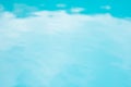 Blue reflection in swimming pool, bright blue blurred background Royalty Free Stock Photo