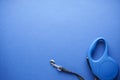 Blue retractable dog leash on a blue background. Space for text, flat lay Royalty Free Stock Photo