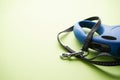 Blue retractable dog leash on a green background, close-up. Space for text Royalty Free Stock Photo