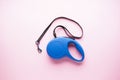 Blue retractable dog leash on a pink background. Flat lay Royalty Free Stock Photo