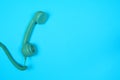 Blue retro telephone on a blue background Royalty Free Stock Photo