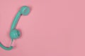 Blue retro telephone on a pink background with copy space Royalty Free Stock Photo