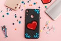 Blue rhinestones and red heart patch on black phone case