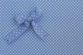 Blue ribbon on polka dots. Royalty Free Stock Photo