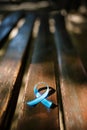 blue prostate ribbon on wooden bench