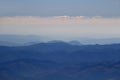 Blue ridges of Slovak Ore Mountains under white clouds