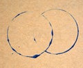 Blue ring stains on brown paper texture background. Royalty Free Stock Photo