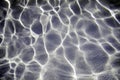 Blue ripped water in swimming pool with sun reflections Royalty Free Stock Photo