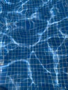 Blue rippled water in the swimming pool  with sun reflection Royalty Free Stock Photo