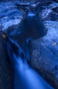 Blue river with fallen leaves