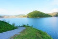 The blue river, green hill and the road near the side of dam. Royalty Free Stock Photo