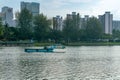 Blue river trash collector boat picks up and collects litter in the river at Kallang Basin, Singapor