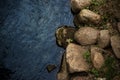 Blue river water and rock shore background Royalty Free Stock Photo