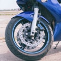 Blue road bike front wheel with disc brake Royalty Free Stock Photo