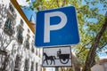 Blue road sign indicating parking for a hitch horses