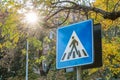 Blue road sign indicating a pedestrian crossing