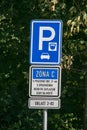 Blue road sign with information about the paid parking zone