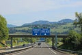 blue road sign with white lettering on the highway