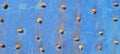 blue rock climbing wall with rustic texture and dots