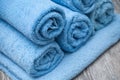 Blue rolled bath towels on wooden table in bathroom Royalty Free Stock Photo