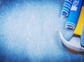 Blue rolled construction drawings claw hammer on metallic background Royalty Free Stock Photo