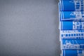 Blue rolled construction drawings on grey background copy space Royalty Free Stock Photo
