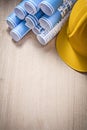 Blue rolled up construction plans hard hat on wooden board copy Royalty Free Stock Photo