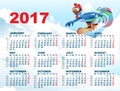 Blue Rooster on snowboard. Calendar with symbol 2017