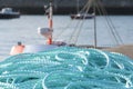 Blue ropes coiled by the harbour