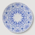 Blue round floral ornament applied to the ceramic plate. Royalty Free Stock Photo