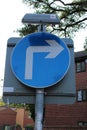 Blue round road sign informing motorists to turn left UK