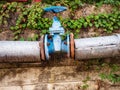 Large blue round valve with pipes for closing the water Royalty Free Stock Photo