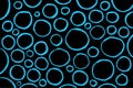 Blue rounds, circles and rings on the black background
