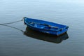 Blue rowing boat on calm water Royalty Free Stock Photo