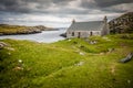 Blue rowing boat and white cottage near to Flodbay on the Isle of Harris Royalty Free Stock Photo