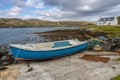 Blue rowing boat and white cottage near to Flodbay on the Isle of Harris Royalty Free Stock Photo