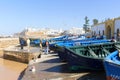 Blue rowing boats hauled onshore