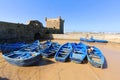 Blue rowing boats moored in port