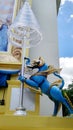 Blue royal lion holding tiered umbrella