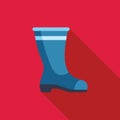 Blue rubber boot standing on a red background Royalty Free Stock Photo