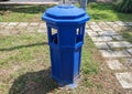 A blue rubbish bin placed in a residential park Royalty Free Stock Photo